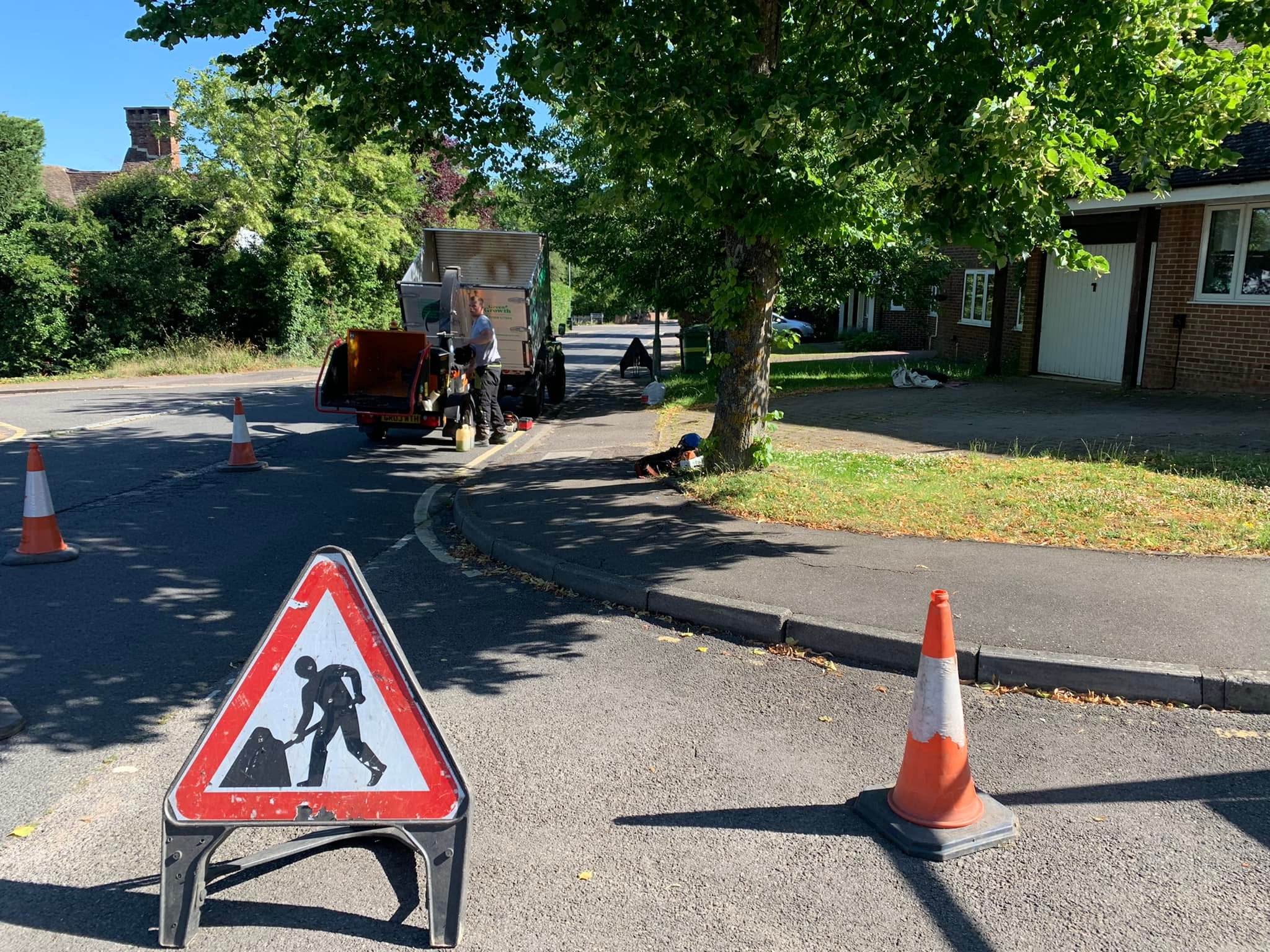 Tree surgeons close a road to conduct emergency tree work.