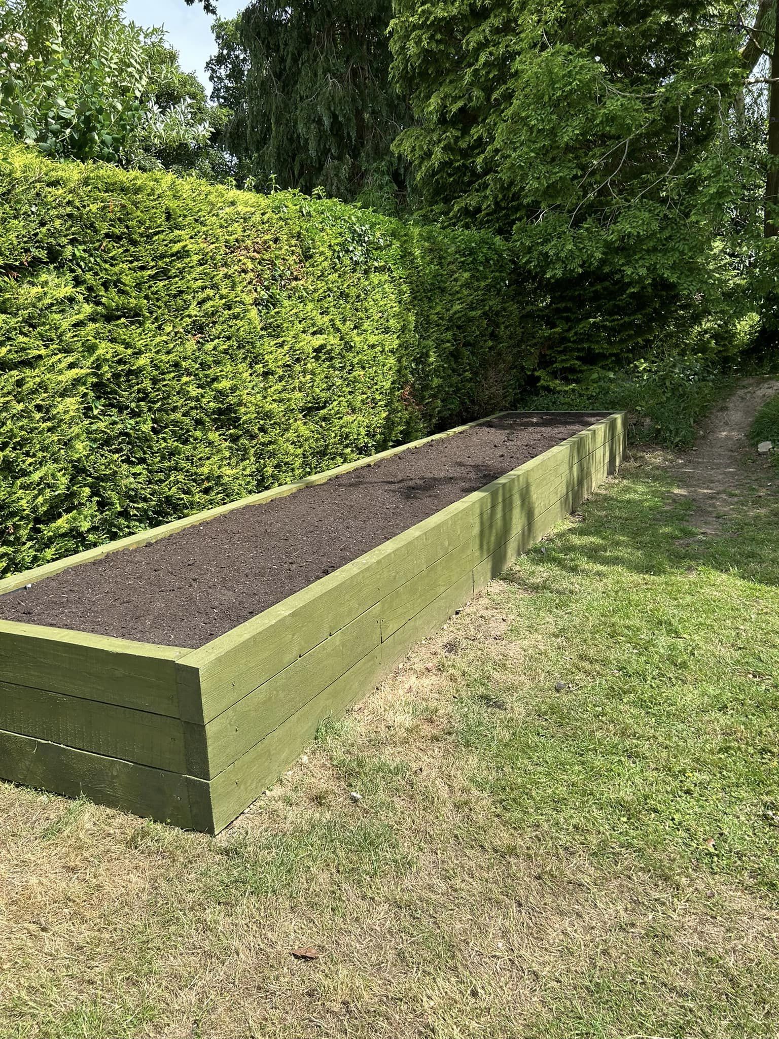 A raised plant bed in a garden, installed by Green Growth.