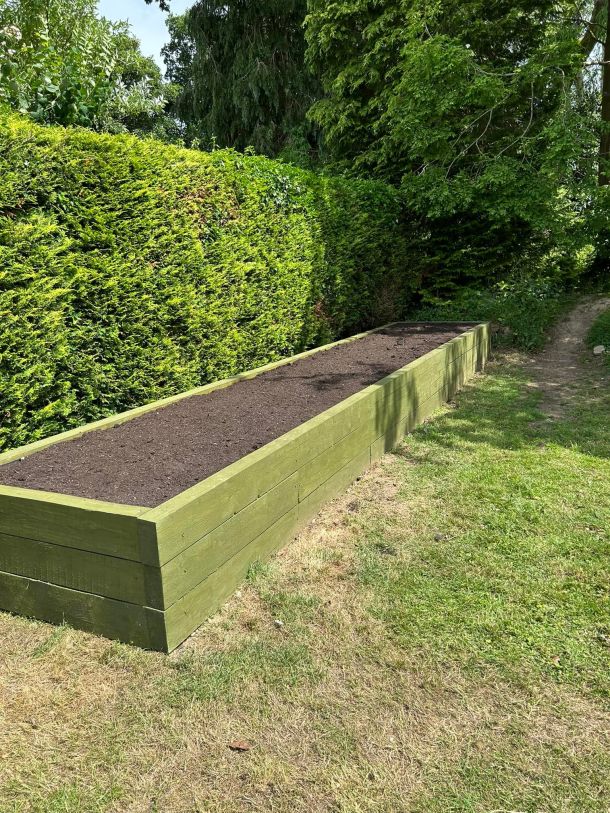 A newly-constructed planter in a garden.