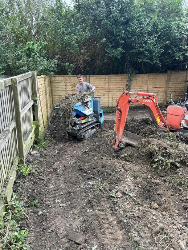 A garden clearance in progress, including a small digger and earth mover.
